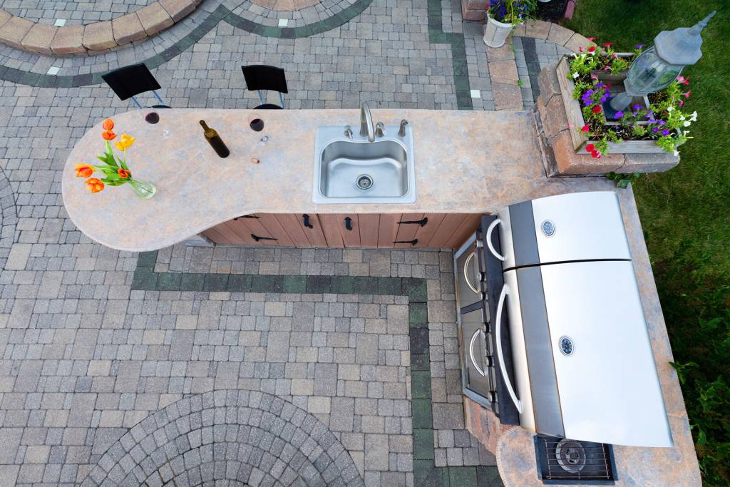 Aerial view of outdoor kitchen patio with grill and sink
